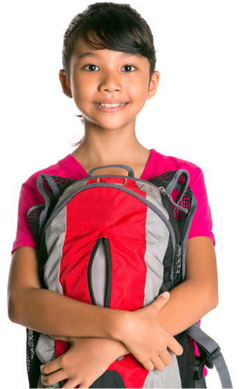 A smiling young girl with both arms wrapped around her red and grey backpack