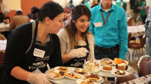 Volunteers serve desert for Thanksgiving dinner at VVRM