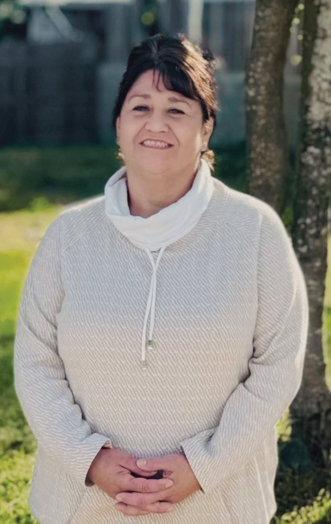 Rescue Mission Alliance Central Coast woman smiling outdoors in a park setting.