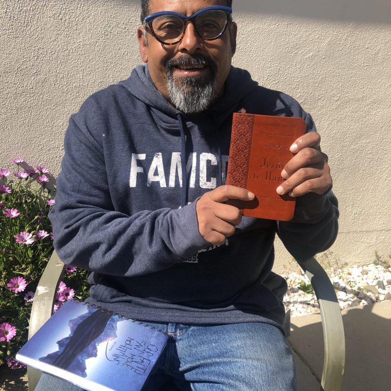 Luis holds a copy of one of his favorite books, “Jesus te llama.”