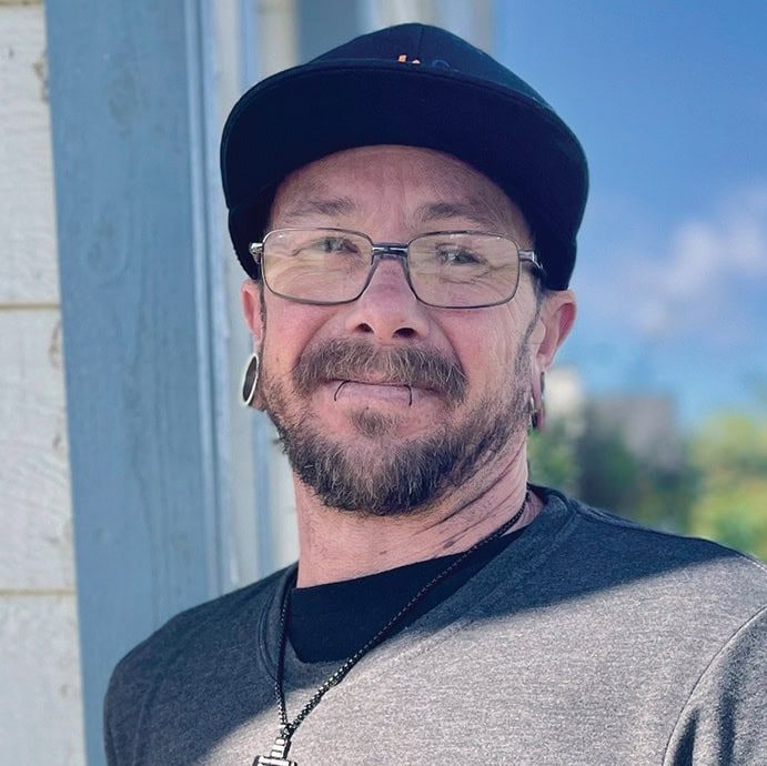 Rescue Mission Alliance Central Coast volunteer smiling outdoors in casual attire.